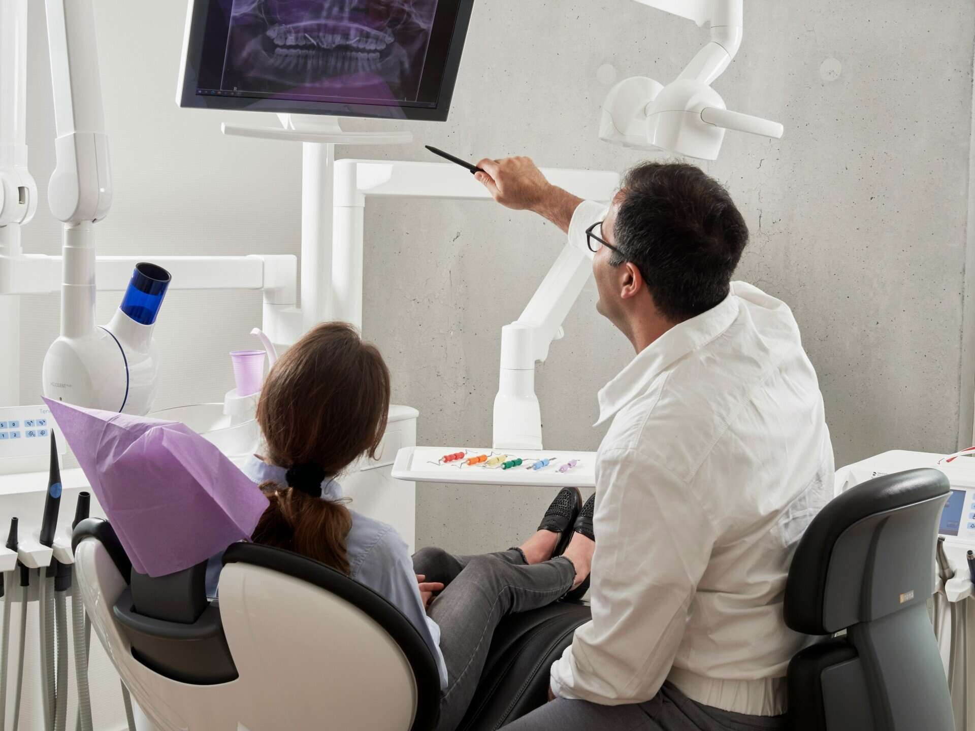 Dentist explaining dental images to patient
